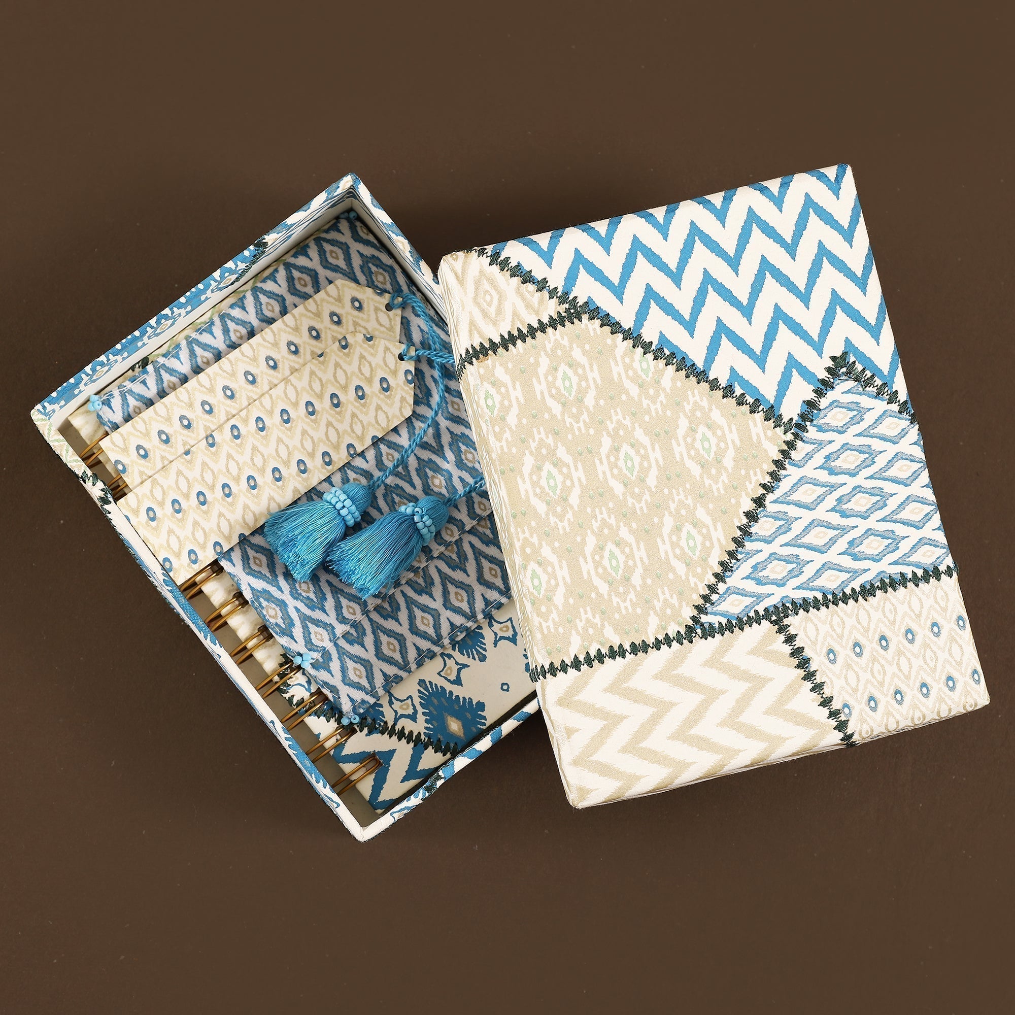 Open fabric box with blue and beige patterns on a brown background