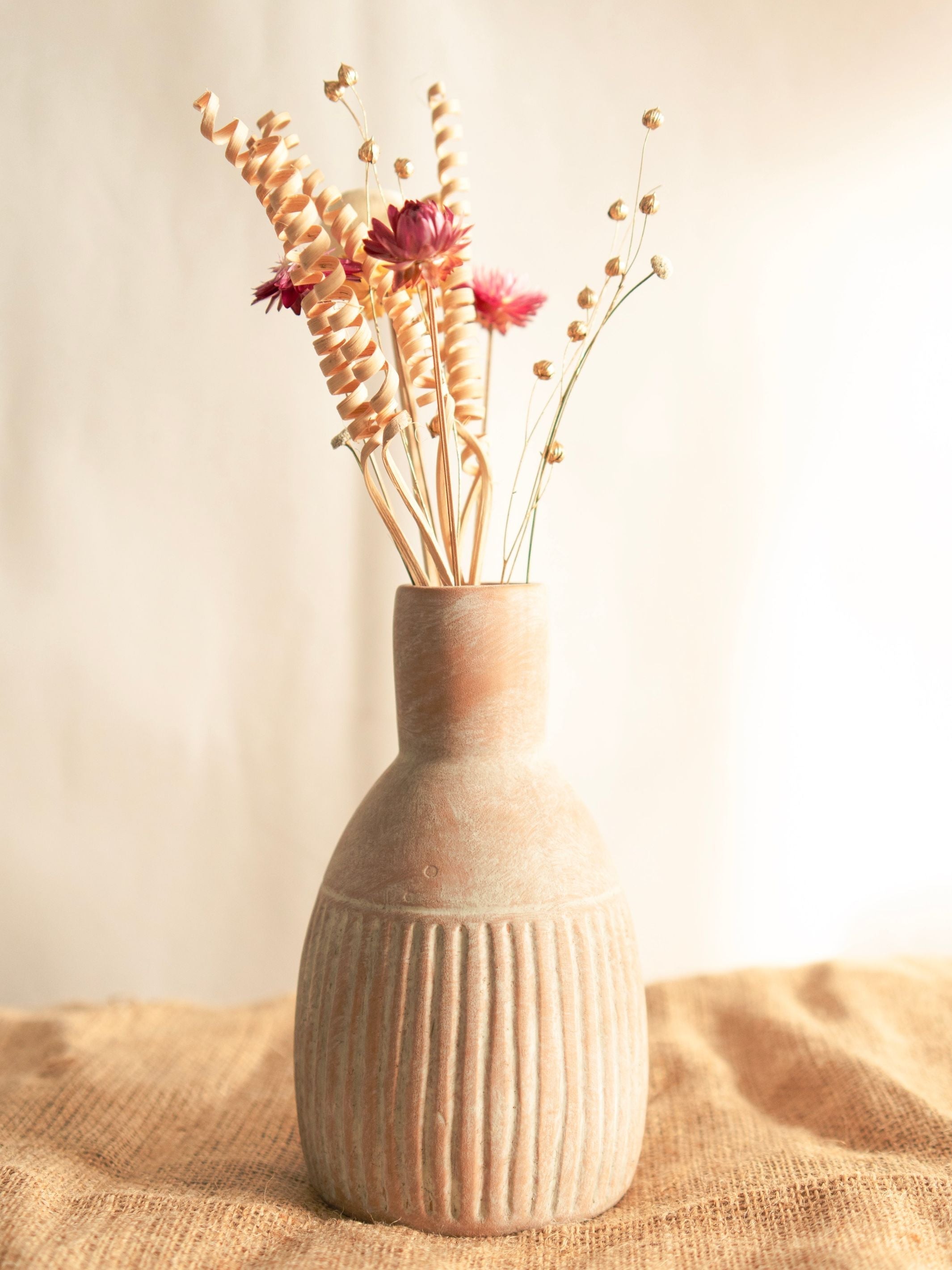 The Earthly vase with dried flower bunch