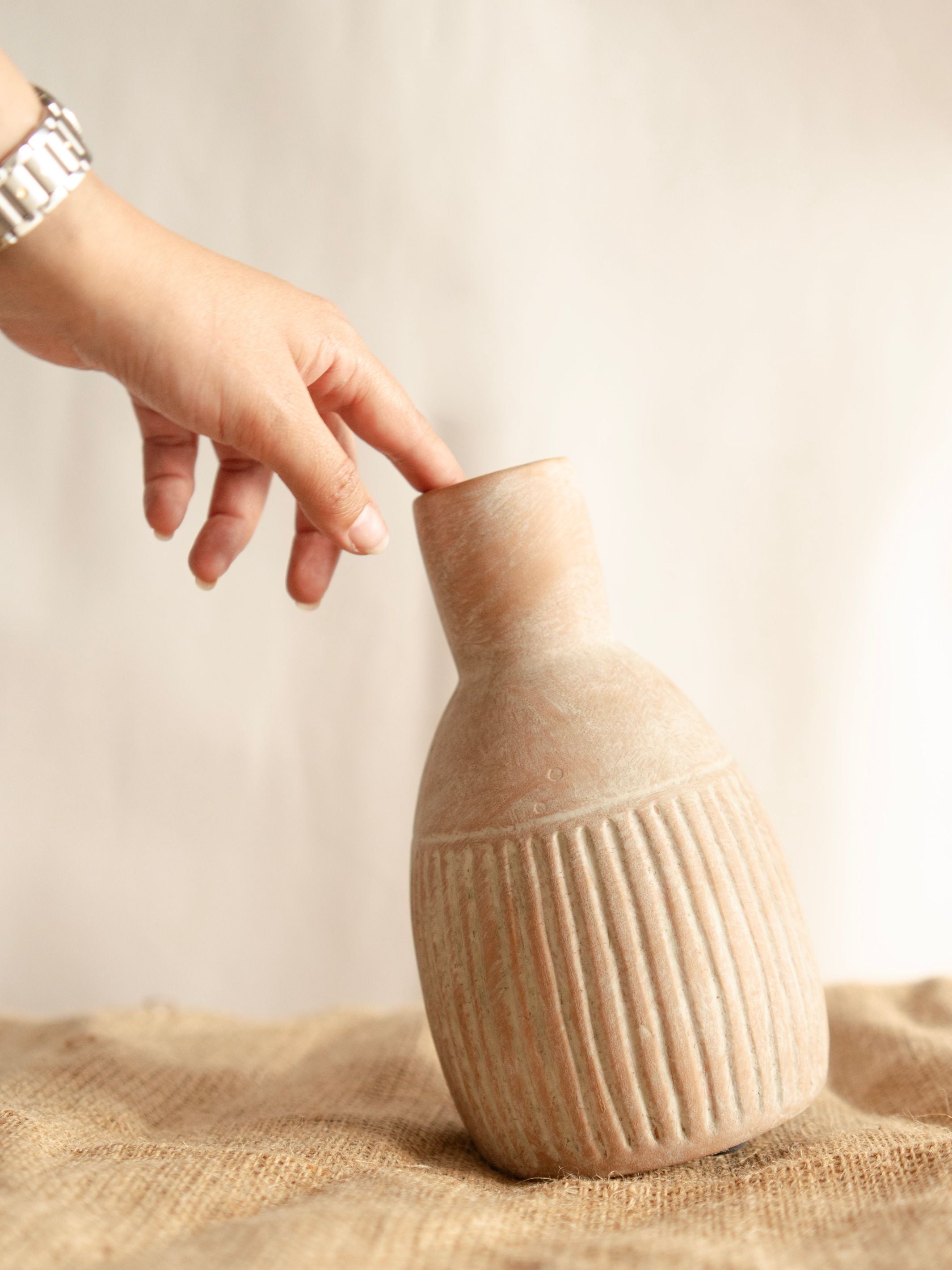 The Earthly vase with dried flower bunch