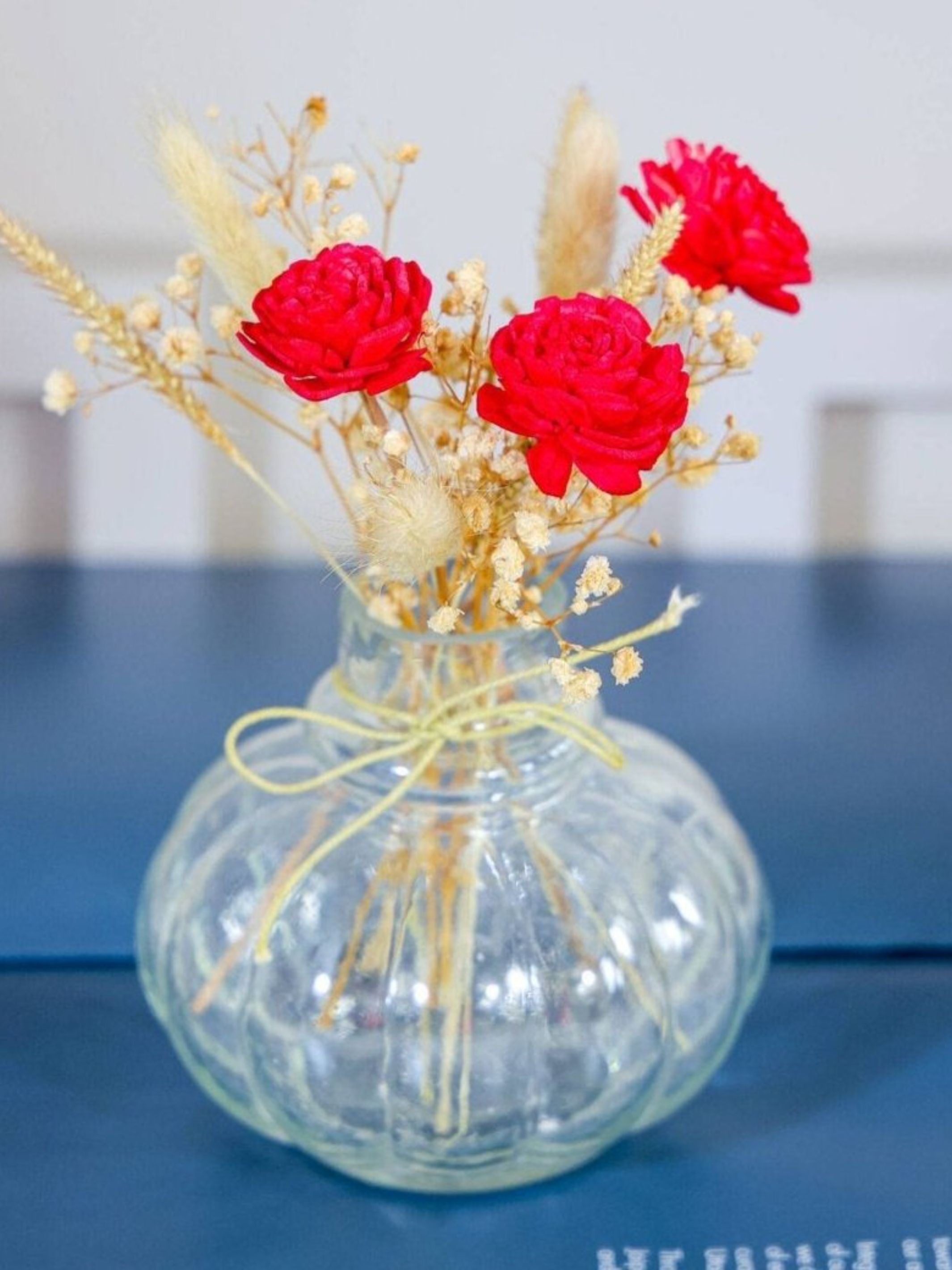 Mini glass bottle vase with red velvet bunch