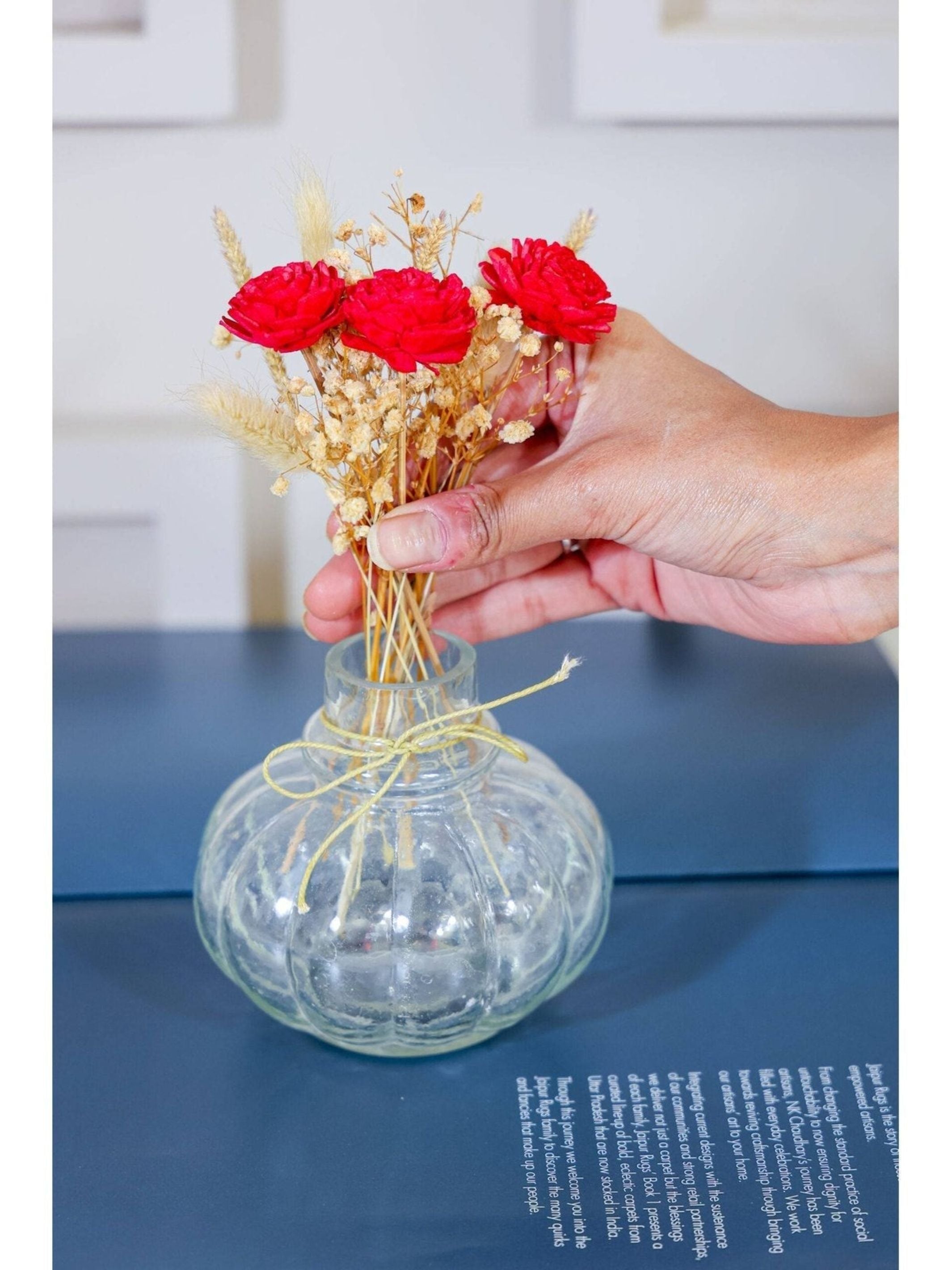 Mini glass bottle vase with red velvet bunch