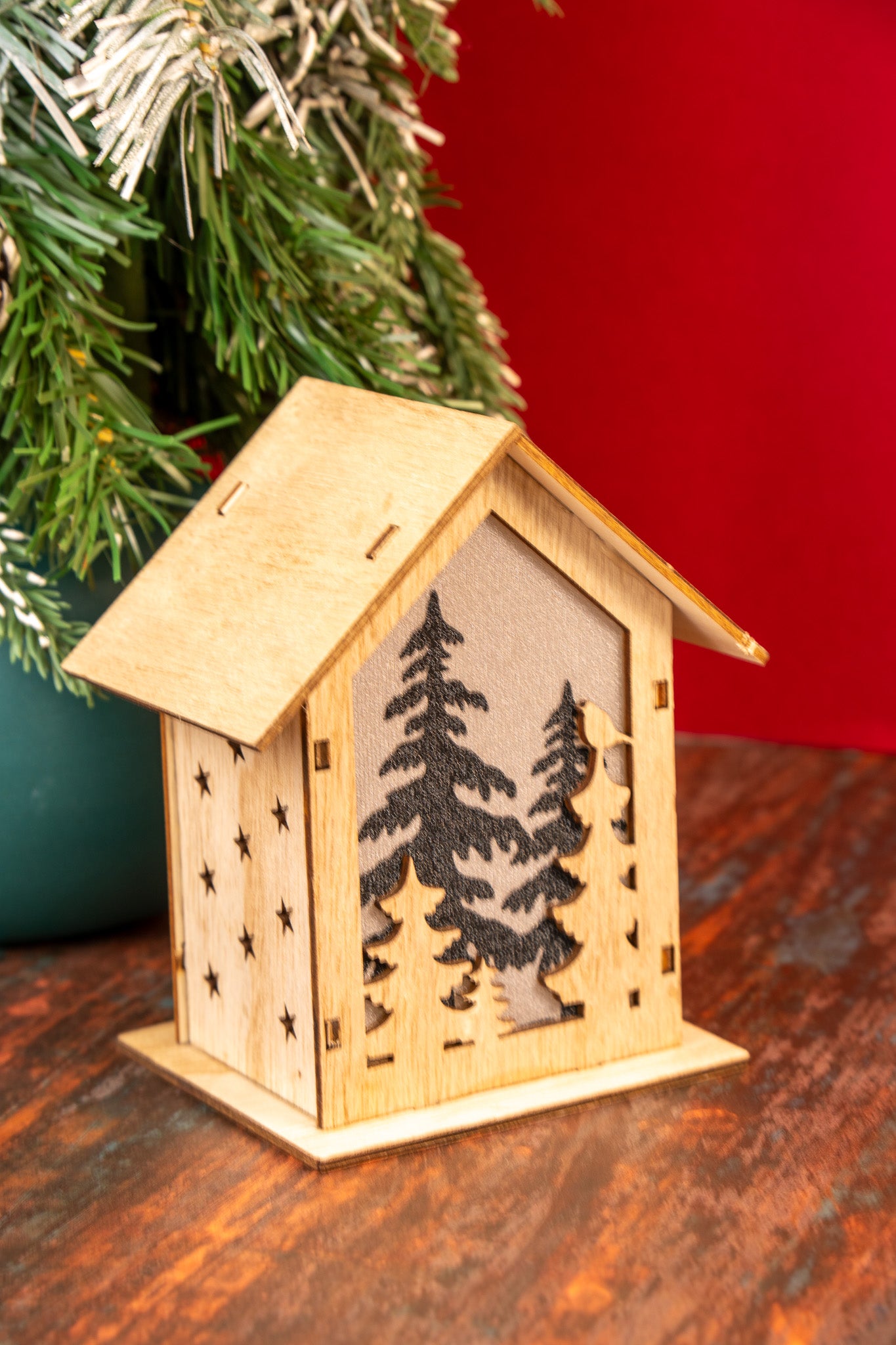 Wooden Christmas House with Forest Silhouette