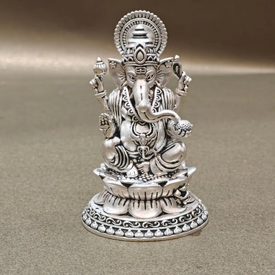 Silver Ganesh idol with intricate detailing on a plain background, Sabera store homepage