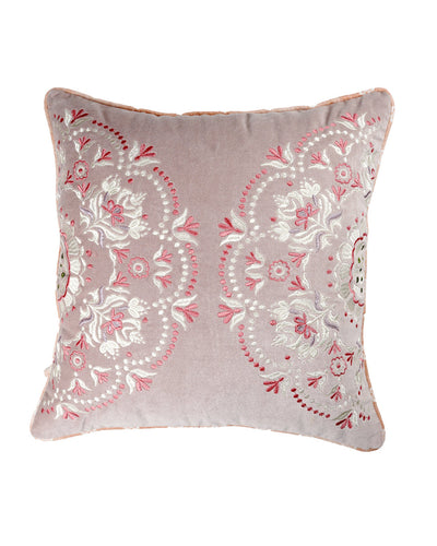 A square-shaped cushion with a velvet fabric featuring a mauve color with a floral embroidery design and a metallic zipper.