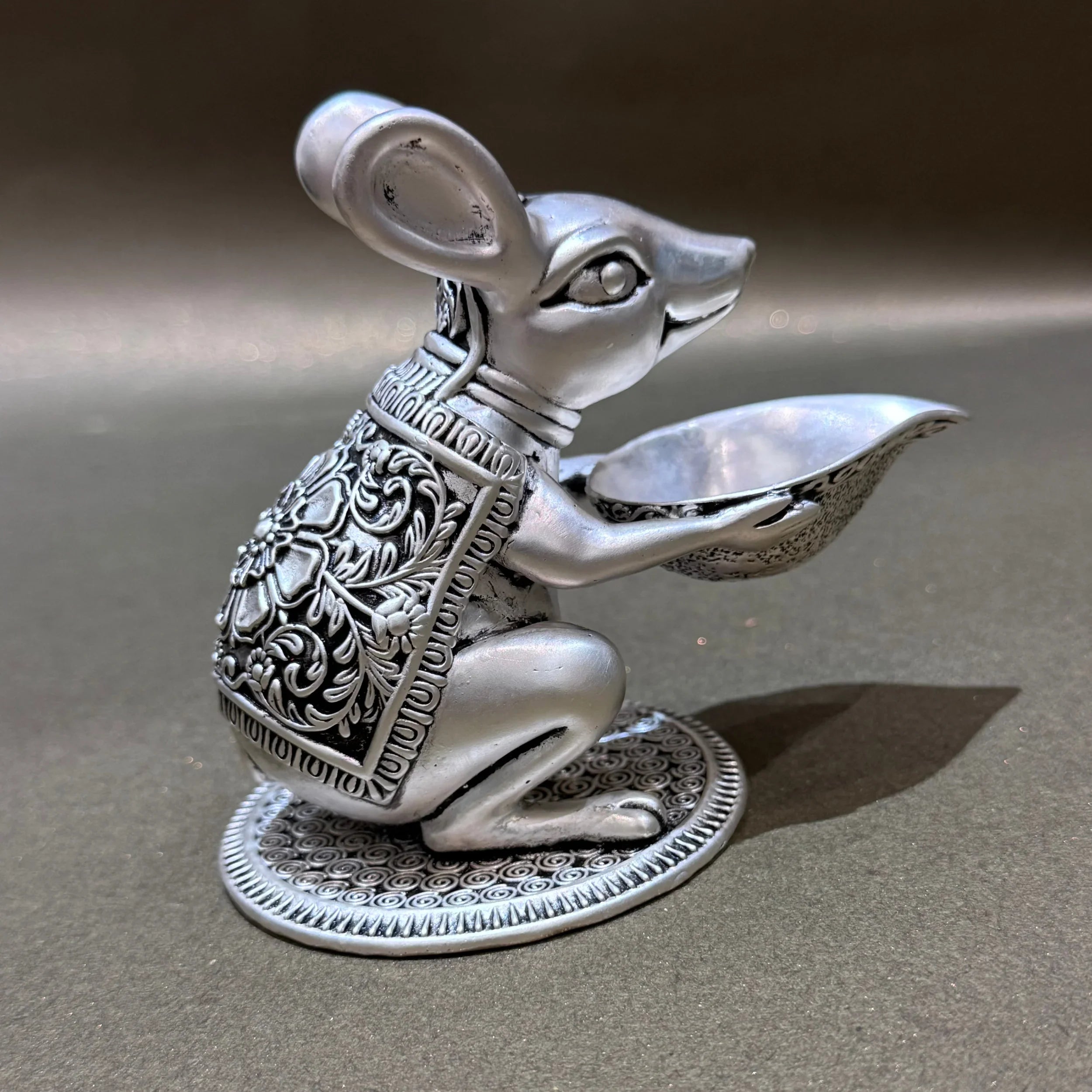 Silver mouse idol holding ornate bowl, decorative figurine on plain background, Sabera