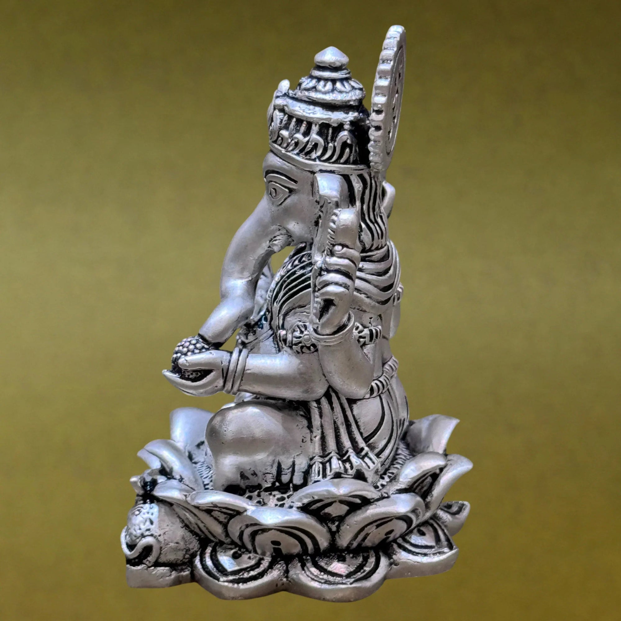 Silver Ganesh idol sitting on lotus, detailed craftsmanship, Sabera decor product