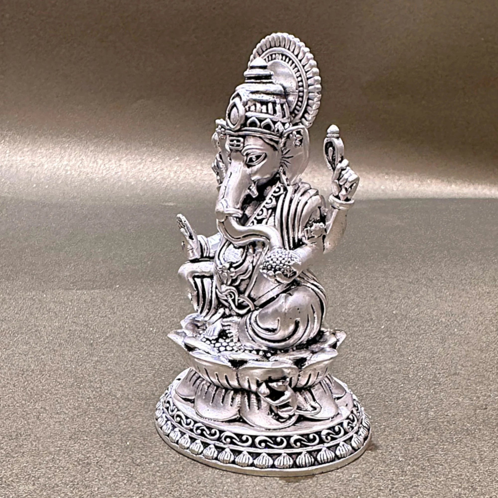Intricately detailed silver Ganesh idol statue on neutral background, Sabera home decor