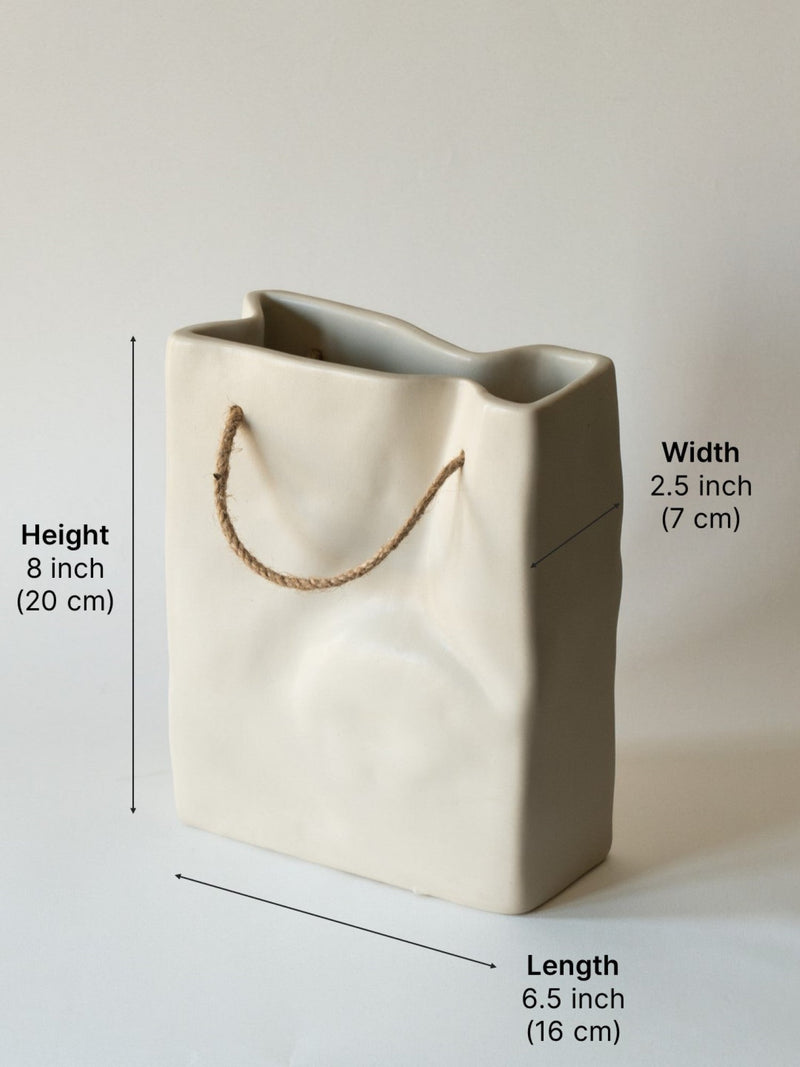 Beige ceramic bag with measurements on a light gray background