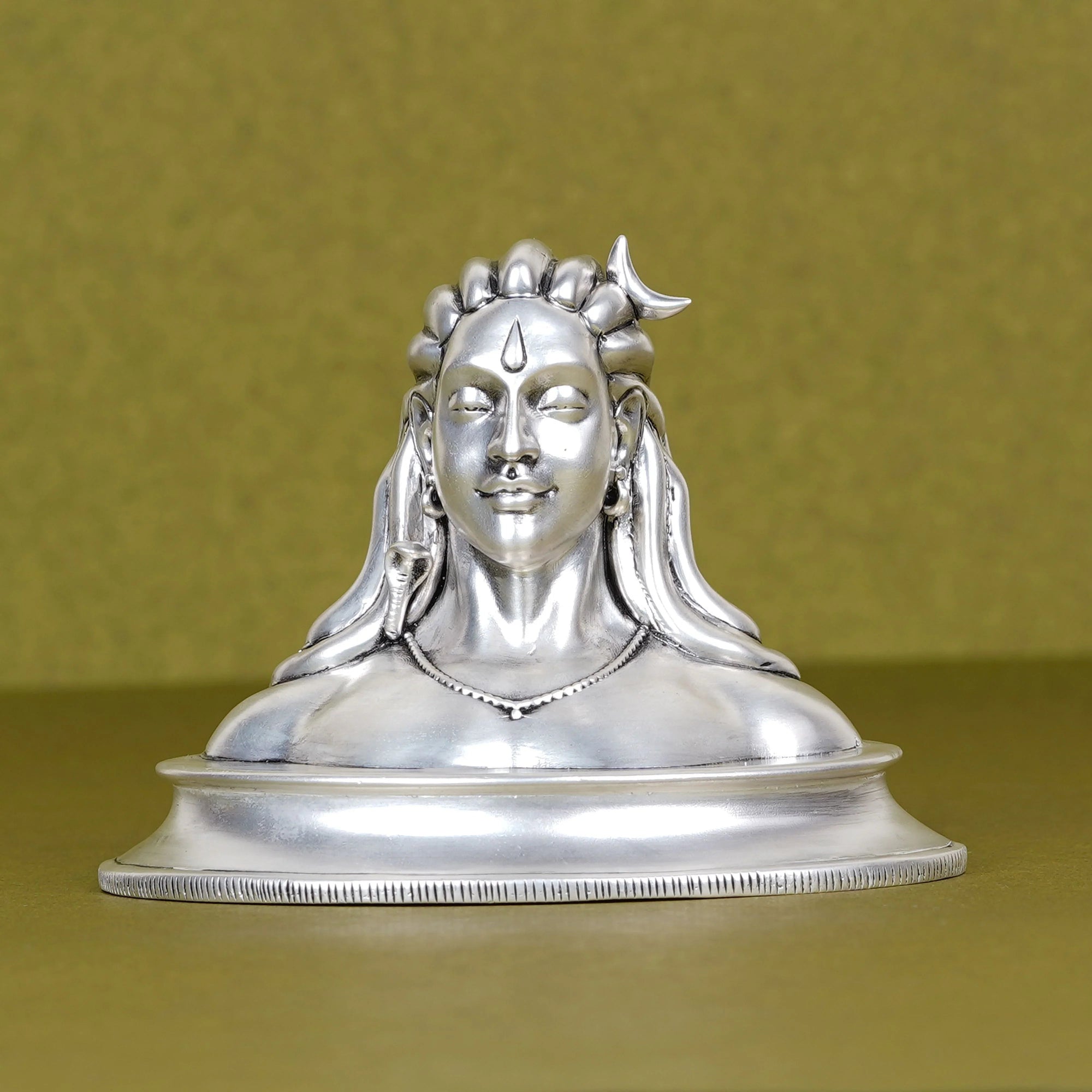 Silver Adiyogi Shiva idol for car dashboard on plain background, Sabera decor