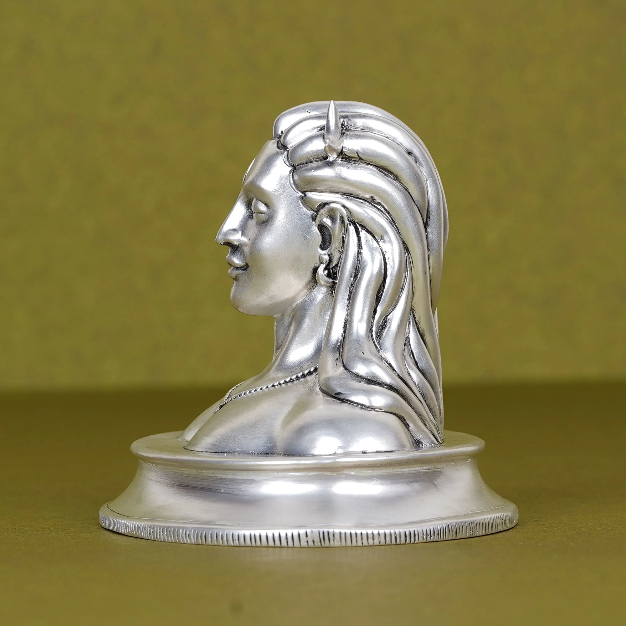 Silver Adiyogi Shiva idol for car dashboard on olive background, Sabera product image