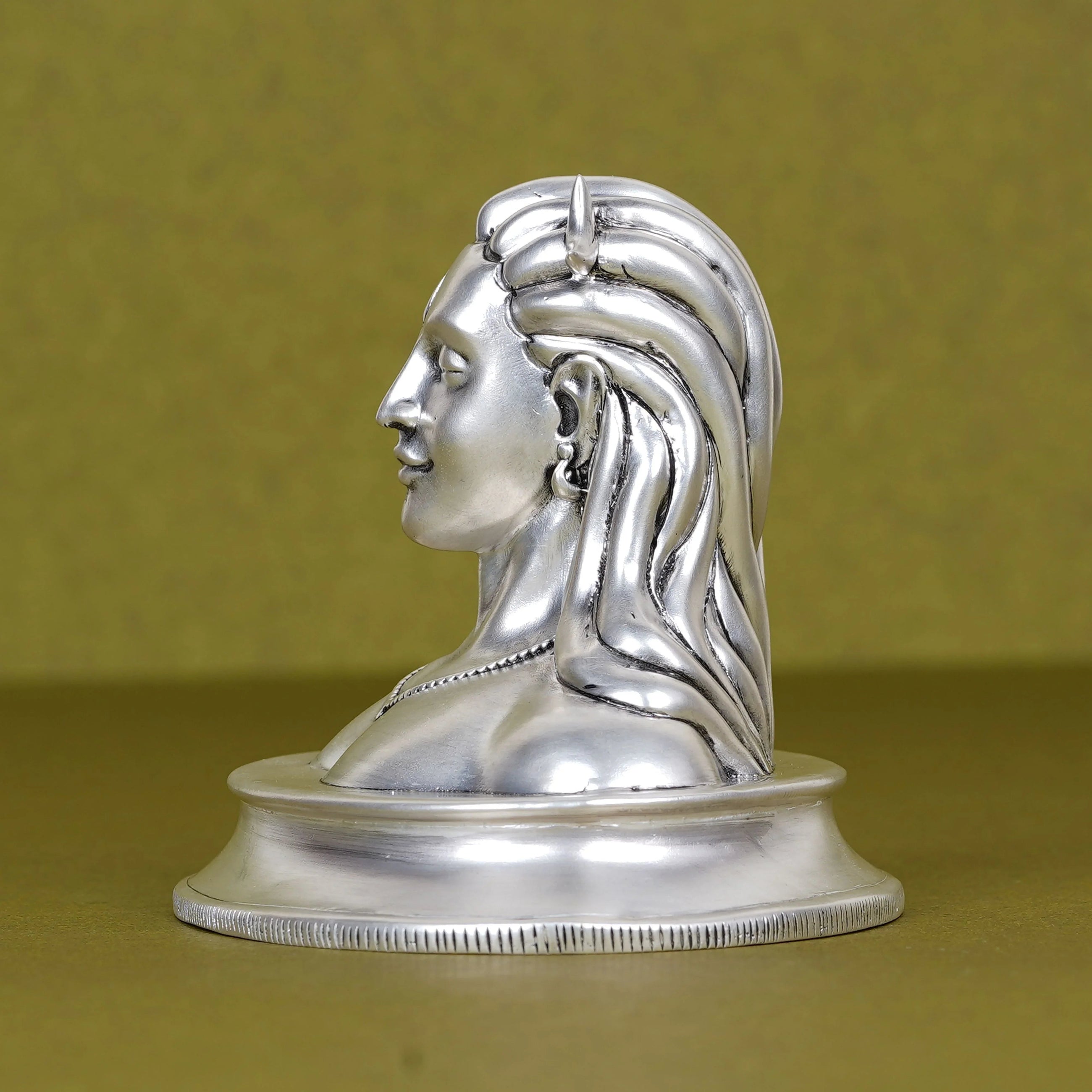 Silver Adiyogi Shiva idol for car dashboard on olive background, Sabera product image