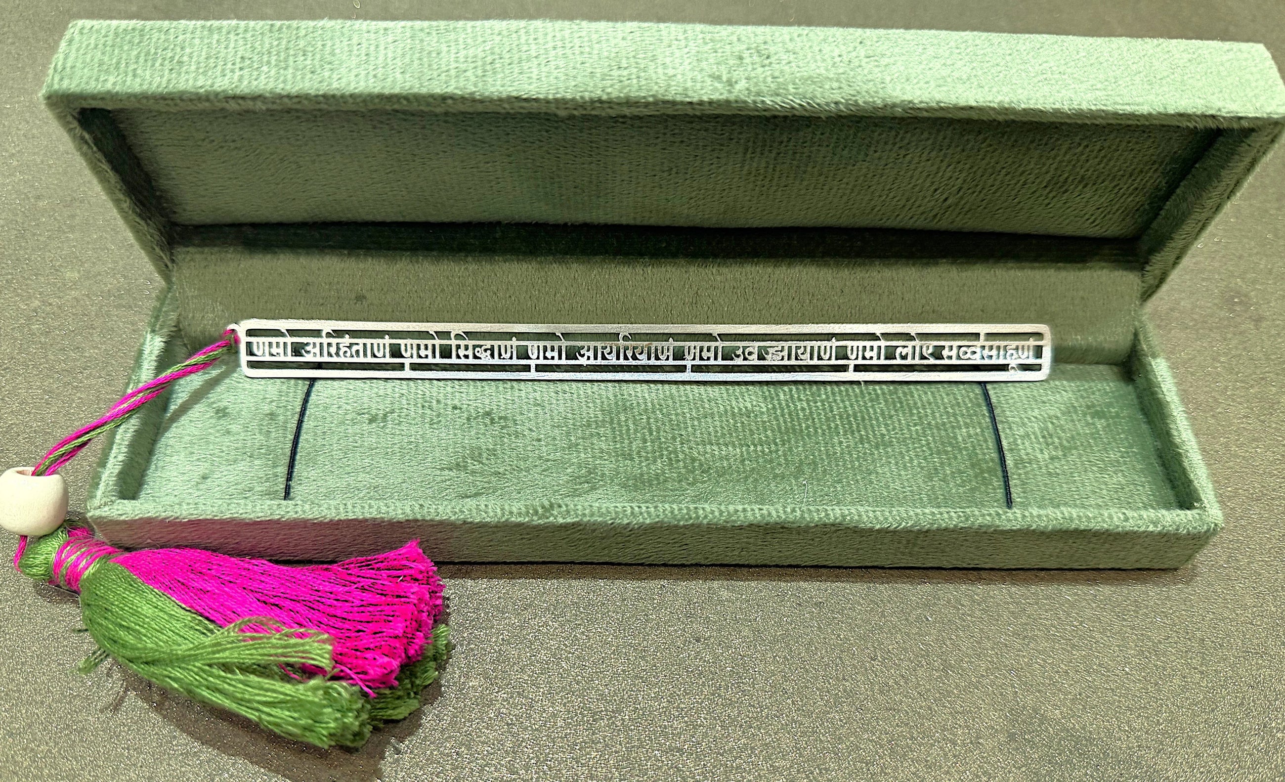 Silver Sanskrit bookmark with green and pink tassel in a green velvet box, Sabera store