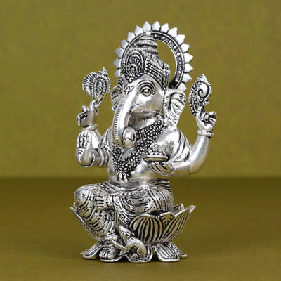 Silver plated Ganesh idol seated on lotus with intricate details, product image for Sabera