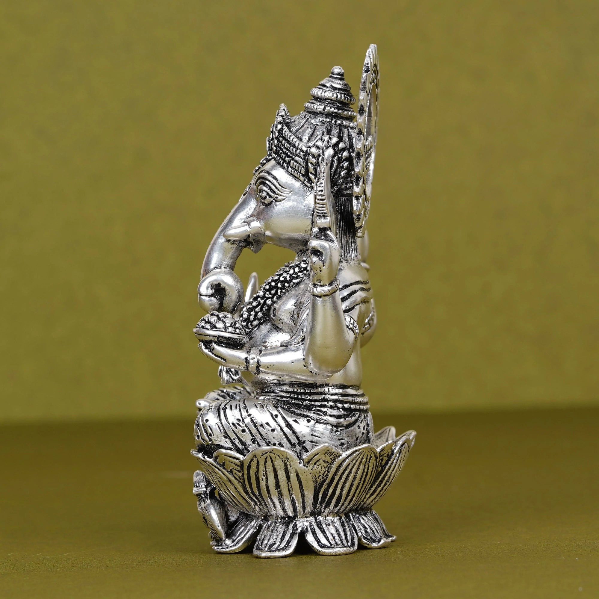 Silver plated Ganesh idol seated on lotus with intricate detailing, Sabera home decor