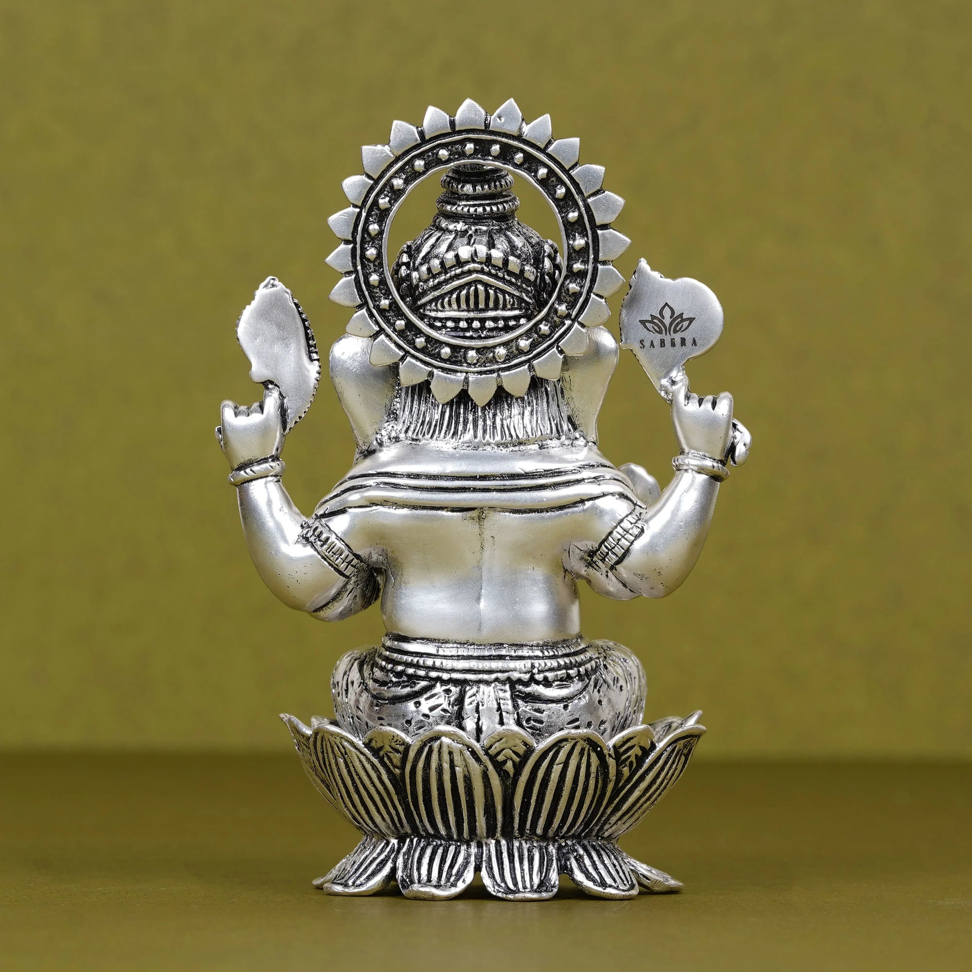 Silver plated Ganesh idol seated on lotus, intricate details, Sabera branding visible