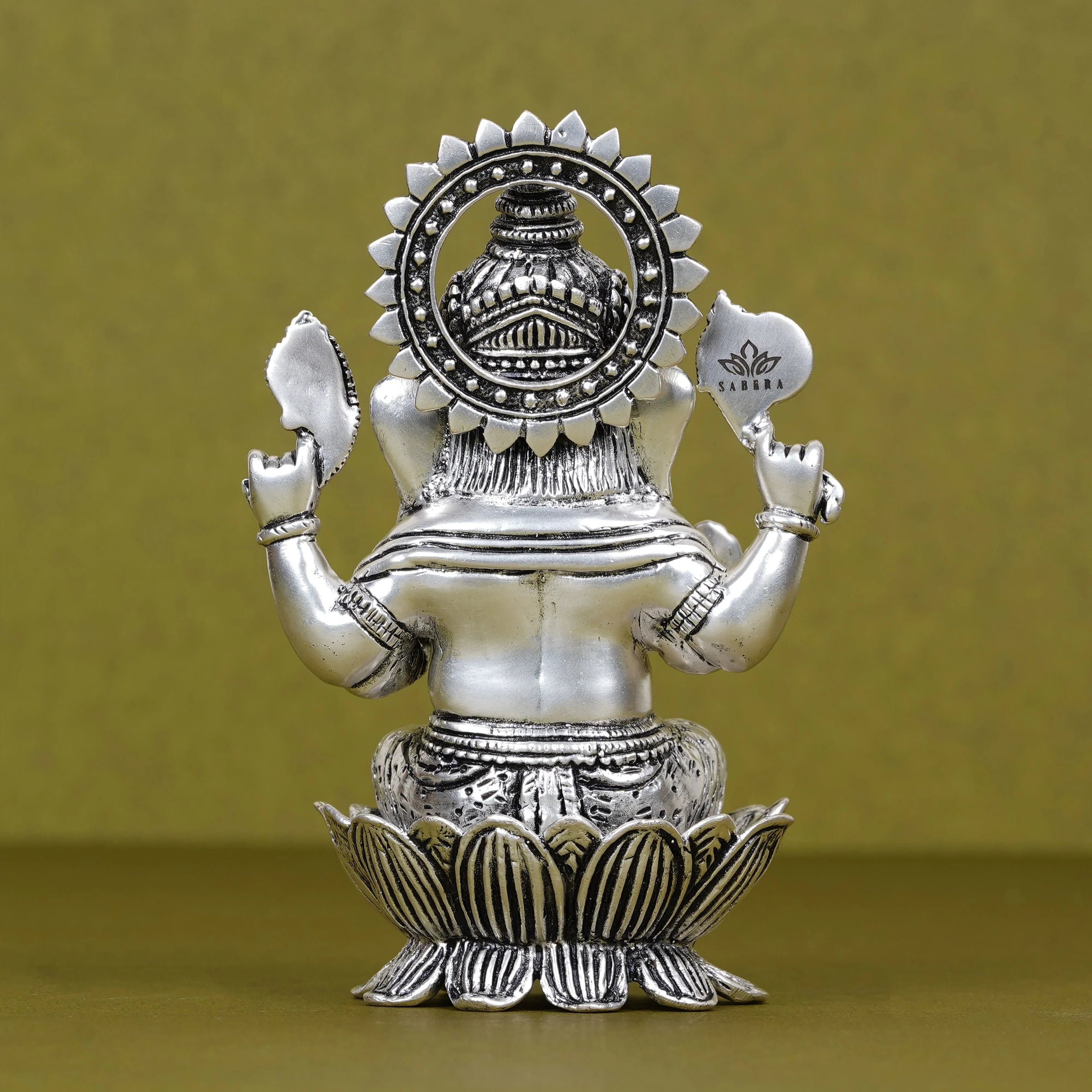 Silver plated Ganesh idol seated on lotus, intricate details, Sabera branding visible