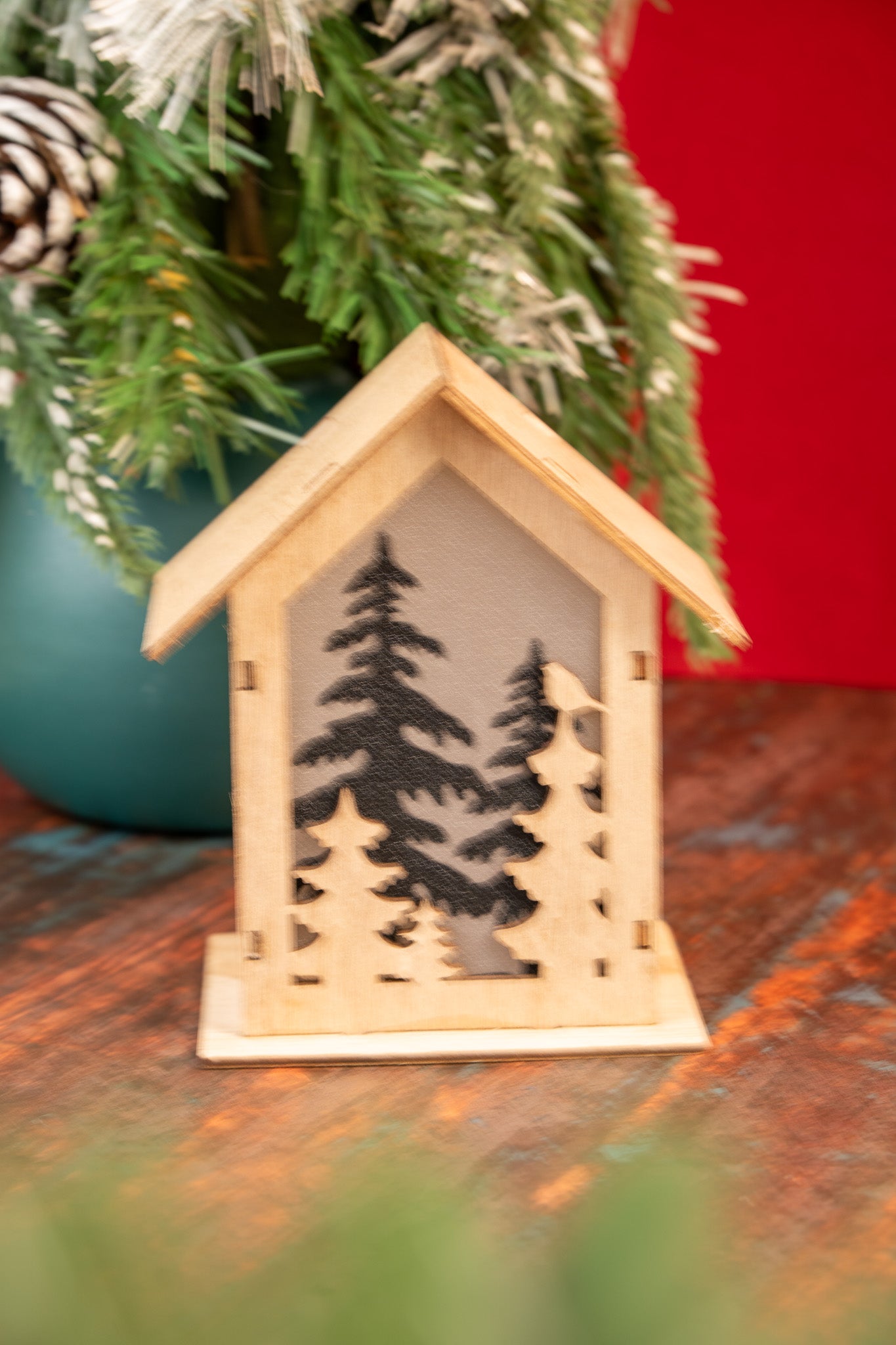 Wooden Christmas House with Forest Silhouette