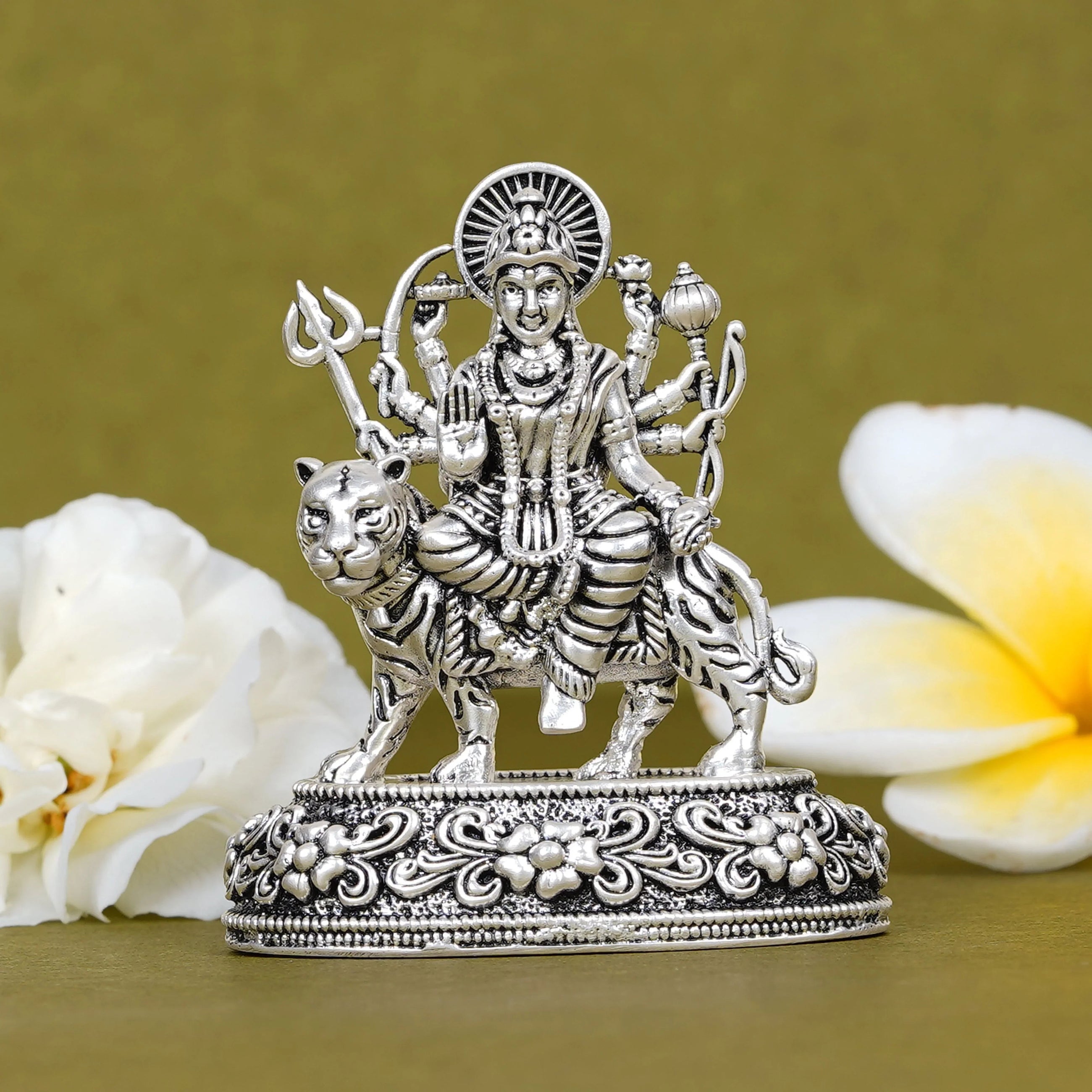 Silver Durga idol on tiger car dashboard décor with floral background, Sabera store