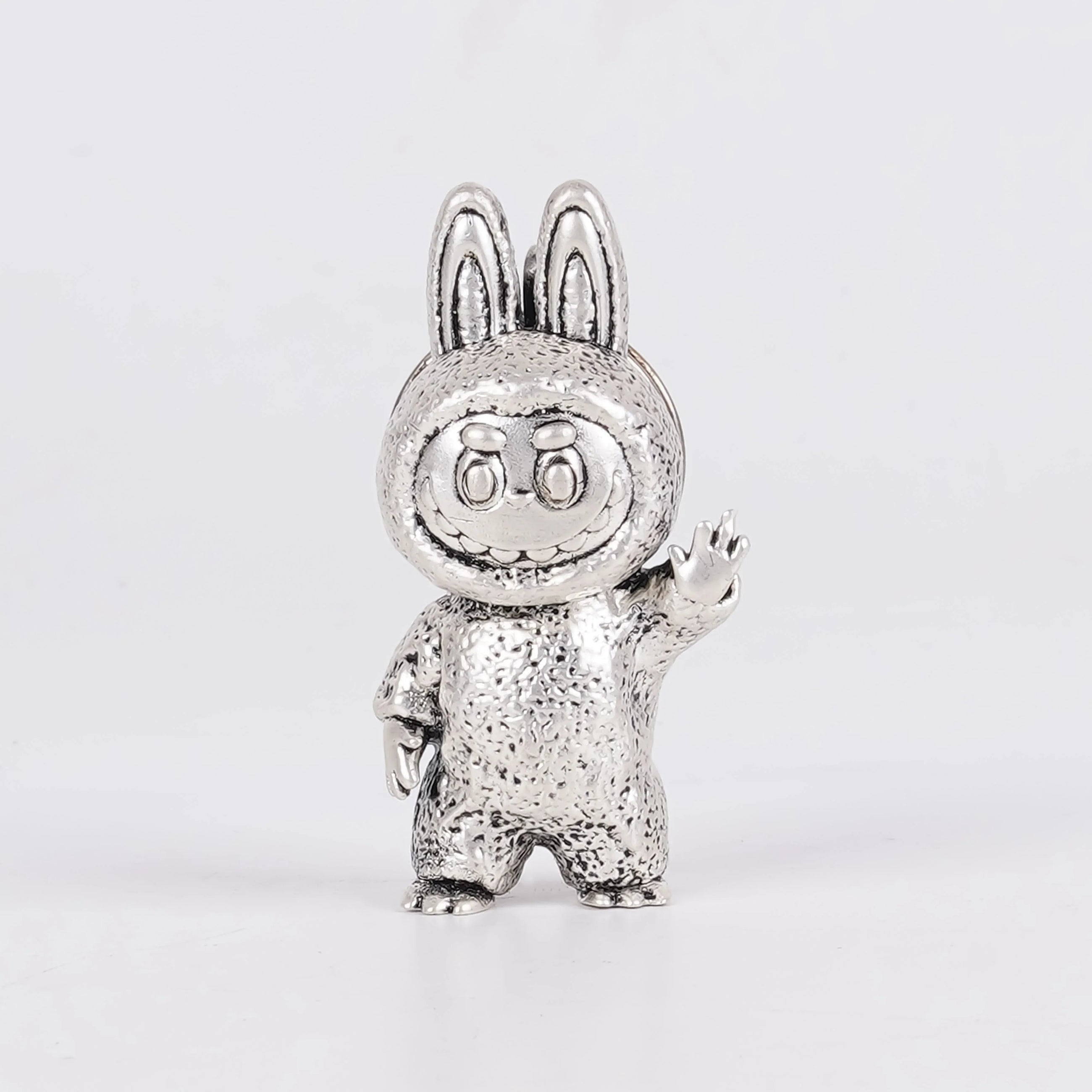 Elegant Labubu silver plated 3D keychain figurine with textured finish on white background