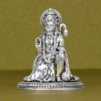 Silver Hanuman Ji idol for car dashboard, detailed design, on plain background