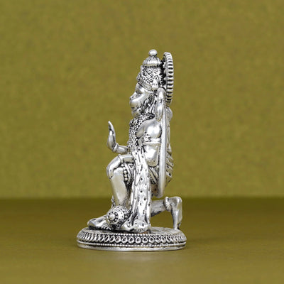 Silver Hanuman idol for car dashboard with detailed ornaments, displayed on a plain background