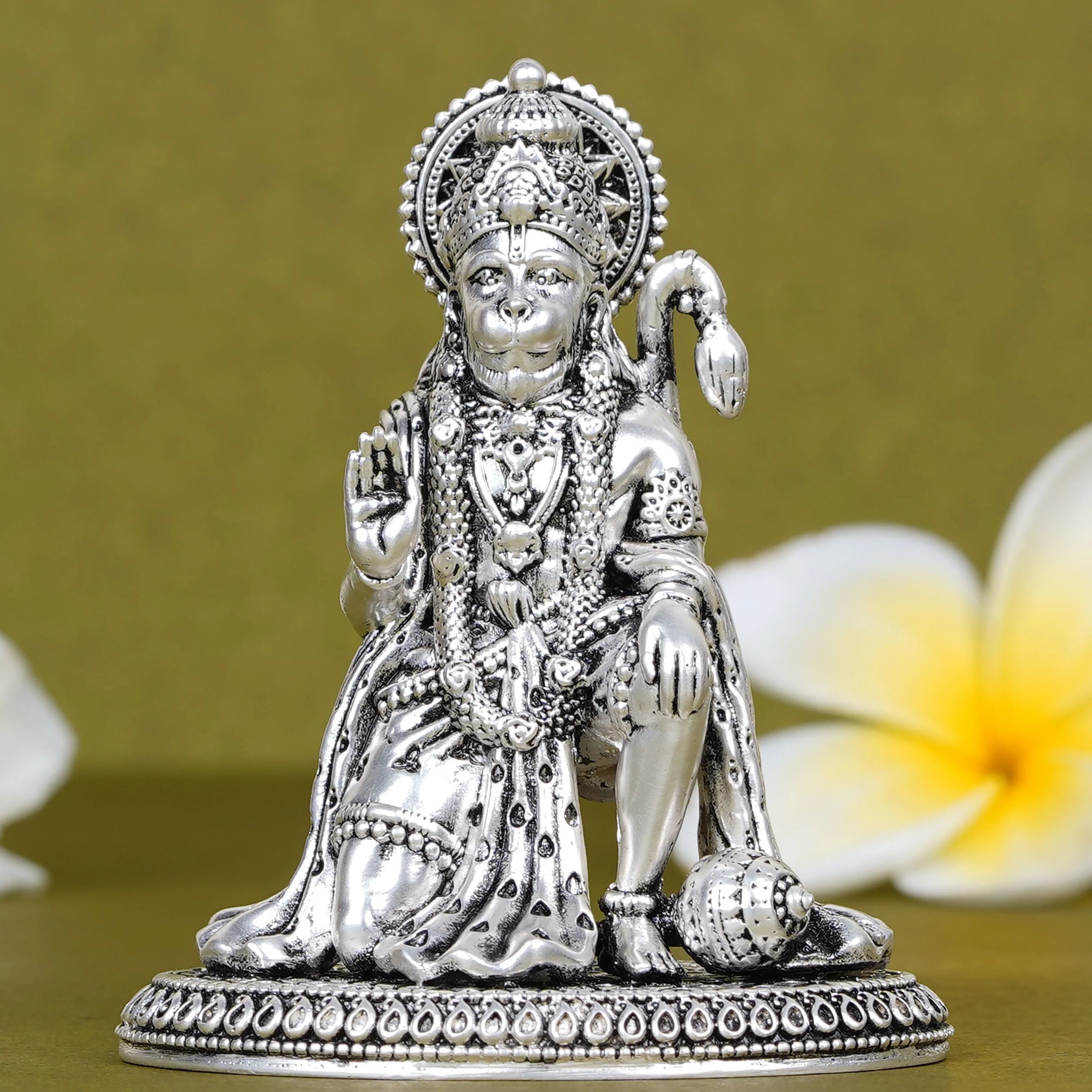 Silver Hanuman idol for car dashboard with intricate detailing, decorative background, Sabera