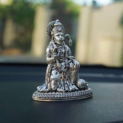 Silver Hanuman Ji idol for car dashboard, detailed design, photographed indoors