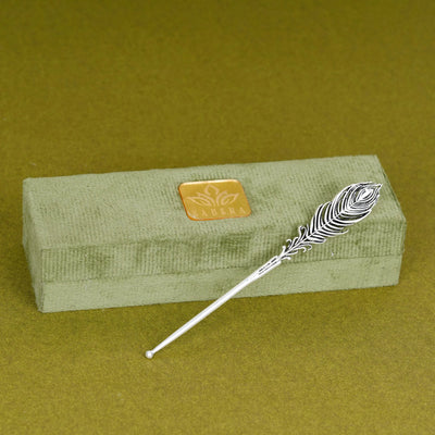 Silver peacock feather tilak stick on green Sabera box, traditional sacred accessory