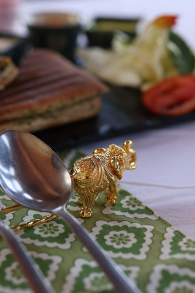 Elephant Carved Spoon Rest in gold plating on a table setting