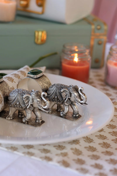 Sabera antique silver elephant napkin rings with stone detail on decorative plate