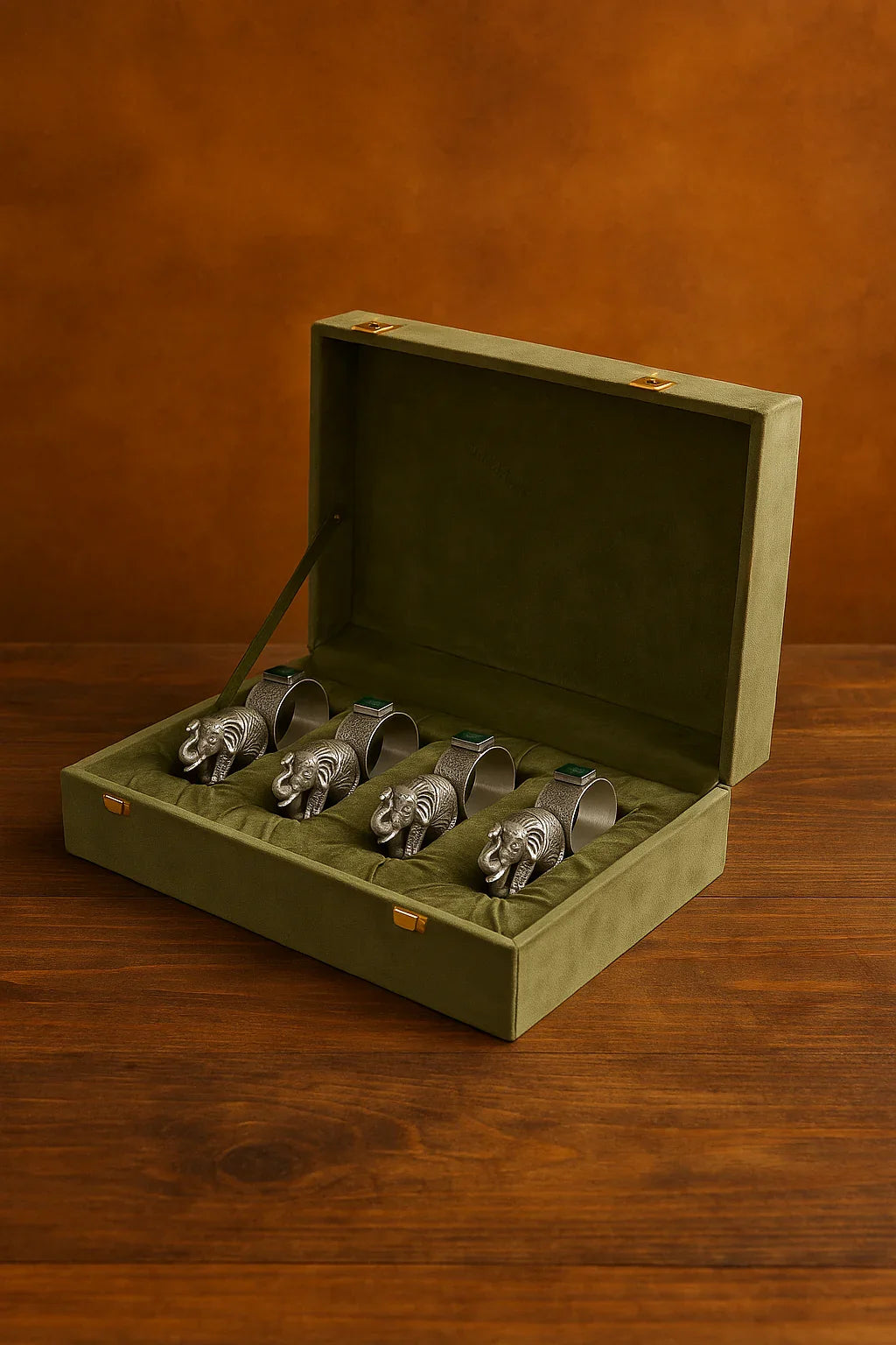 Sabera antique silver elephant napkin rings set in green velvet box on wooden table