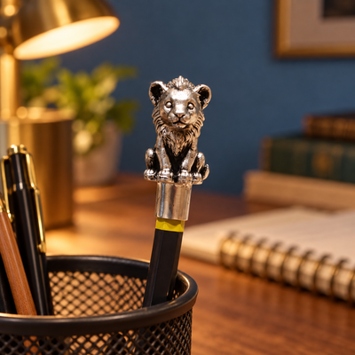 Sheru lion cub pencil topper on a pencil standing in a desk pen holder