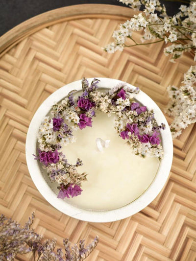 Soy Scented White Candle With White Dry Flowers On Top In A Concrete Jar